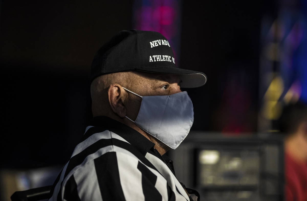 Steve Esposito, a time keeper with the Nevada State Athletic Commission, watches the action dur ...