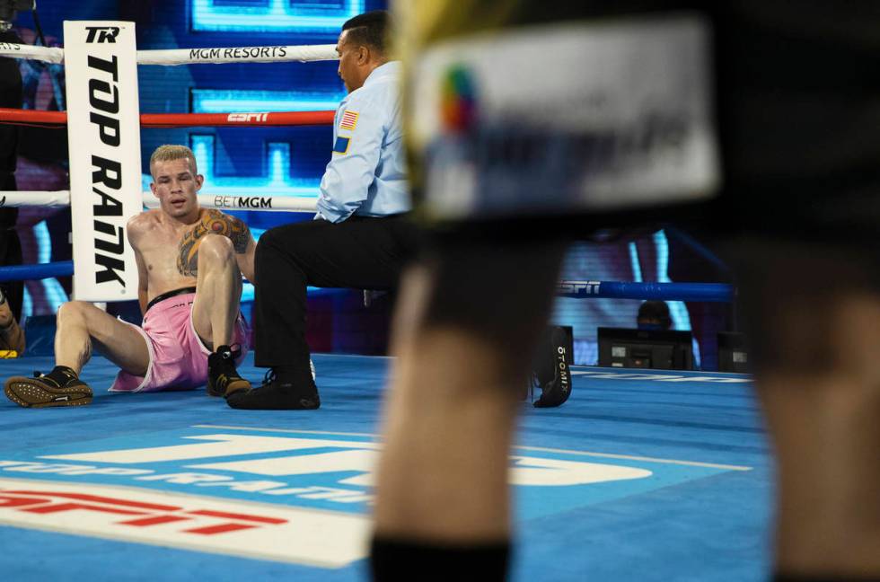 Jayson Velez, back/left, tries to recover after being knocked down by Oscar Valdez during their ...