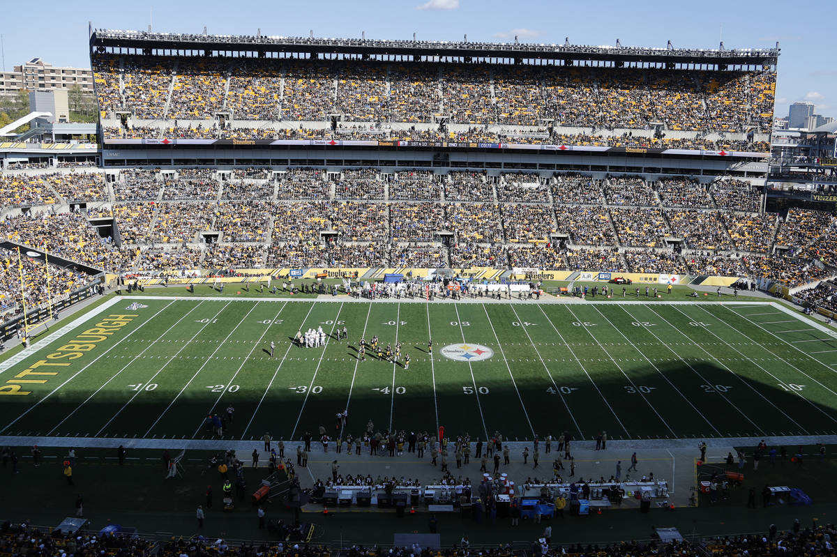 The Pittsburgh skyline raise above Heinz Field as fans watch the second half of an NFL football ...