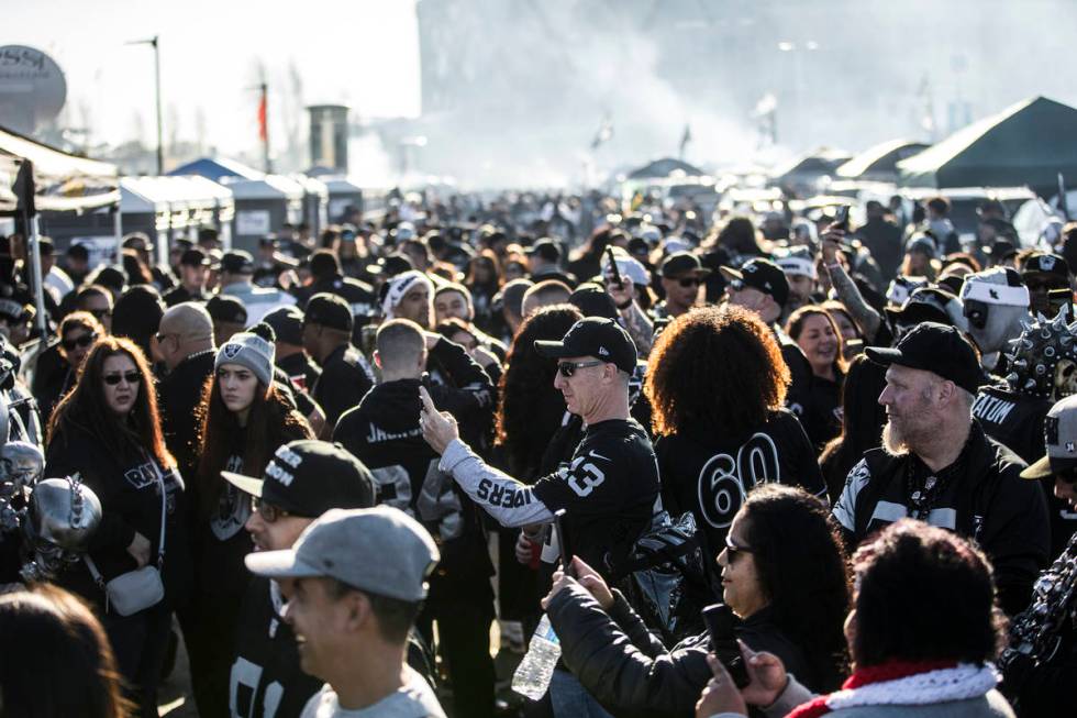 Fans tailgate outside the Oakland Coliseum before the start of an NFL football game between the ...