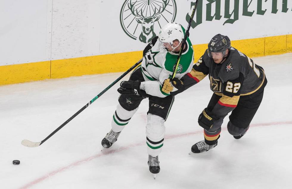 Dallas Stars' Radek Faksa (12) and Vegas Golden Knights' Nick Holden (22) battle for the puck d ...