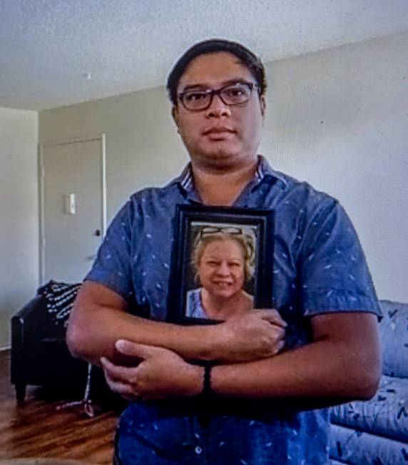 Roderick Alimusa holds a photograph of his mother, Maria Alimusa, at his home in Westminster, C ...