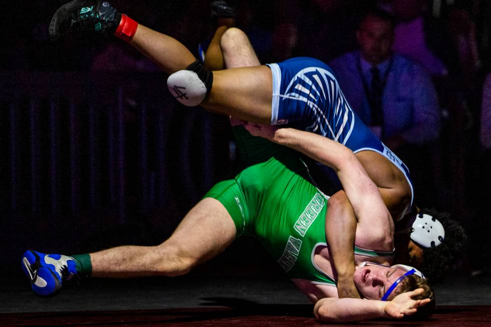 Foothill's Micah Schneider, top, drives Green Valley's Derek Recktenwald into to the mat in the ...