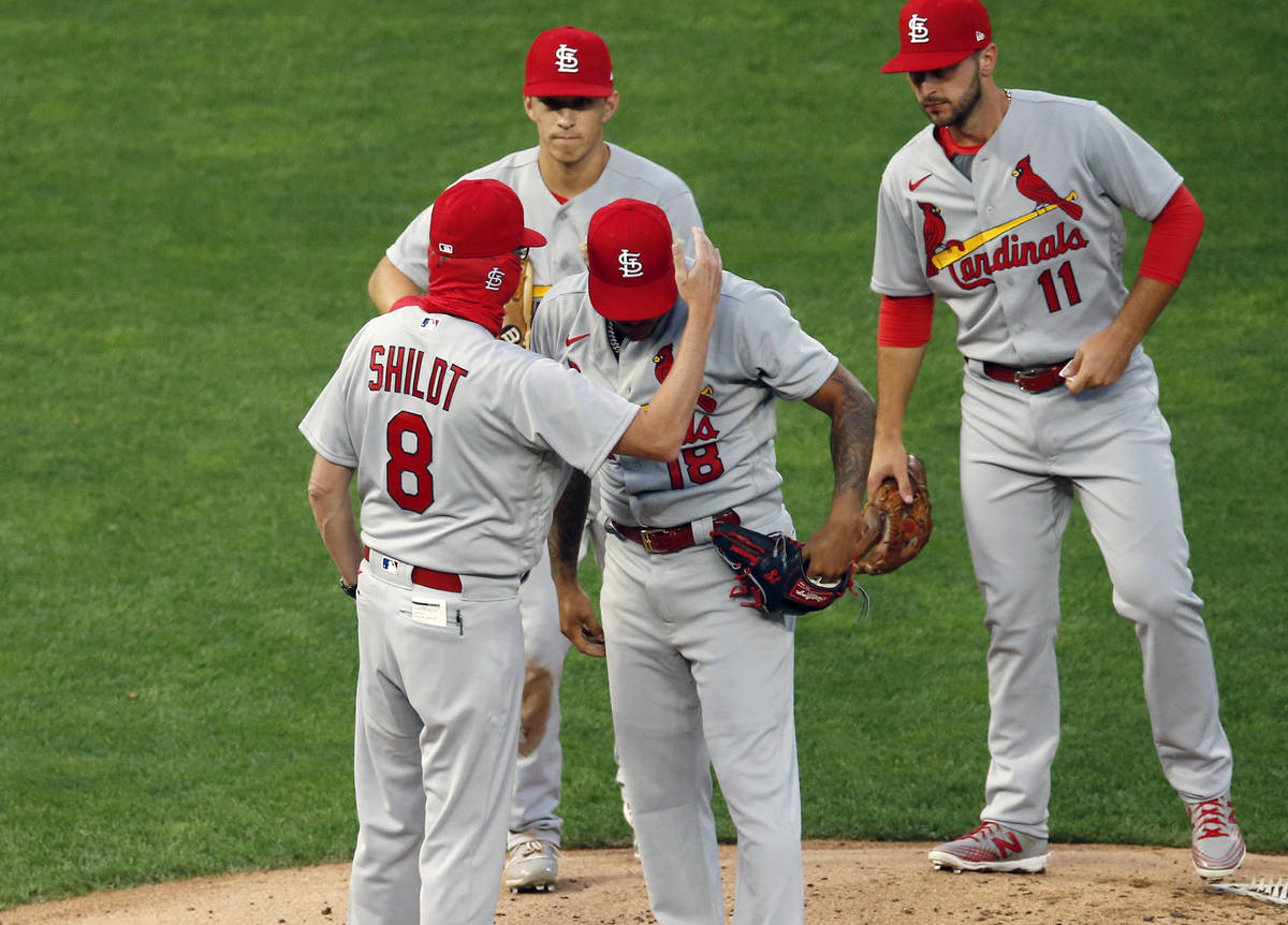 St. Louis Cardinals manager Mike Shildt (8) consoles pitcher Carlos Martinez on the cap as he p ...