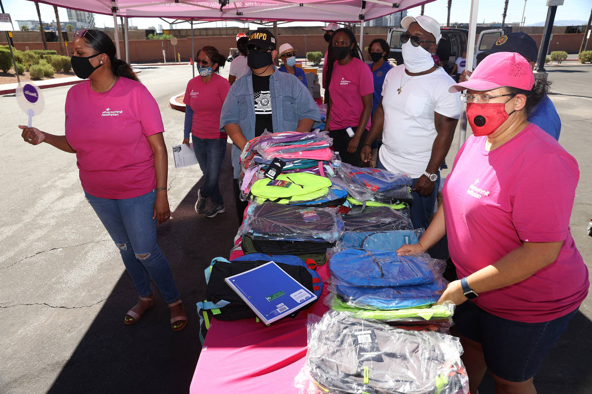 Backpacks are given away during an event hosted by Clark County Commission Vice Chairman Lawren ...