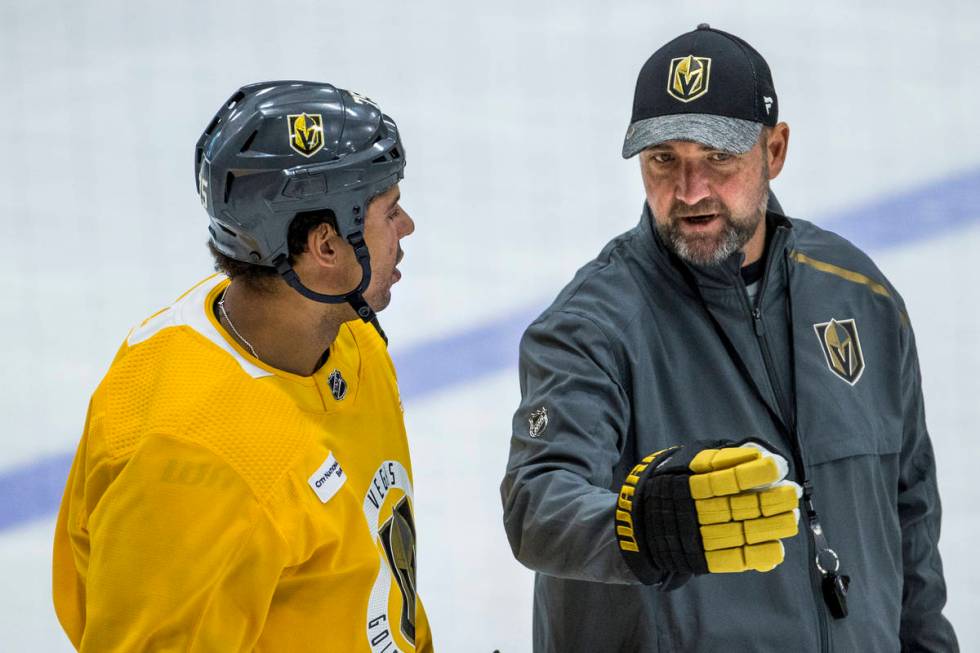 Vegas Golden Knights right wing Ryan Reaves (75, left) listens on the ice to head coach Peter D ...