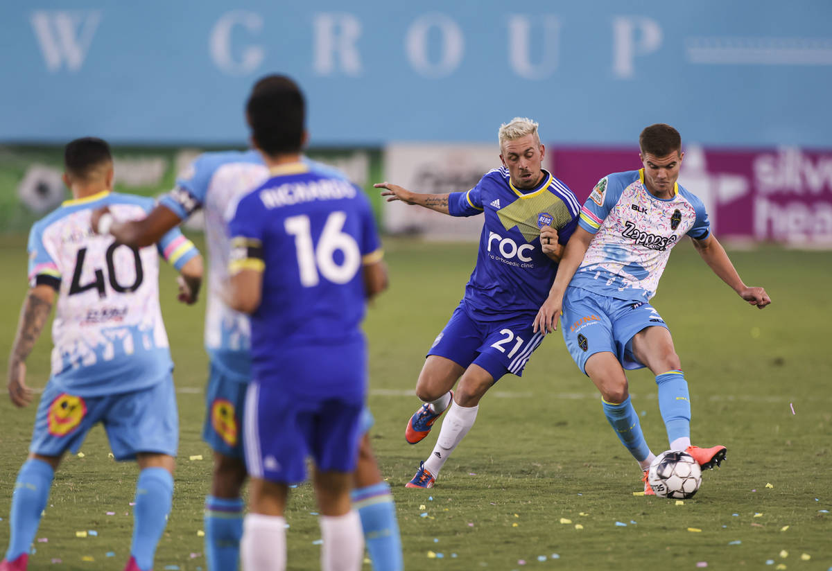 Las Vegas Lights FC's Johnny Fenwick (3) moves the ball under pressure from Reno 1868 FC's Core ...