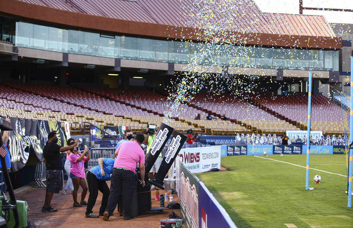 A confetti canon goes of among a backdrop of empty seats without fans during the first half of ...