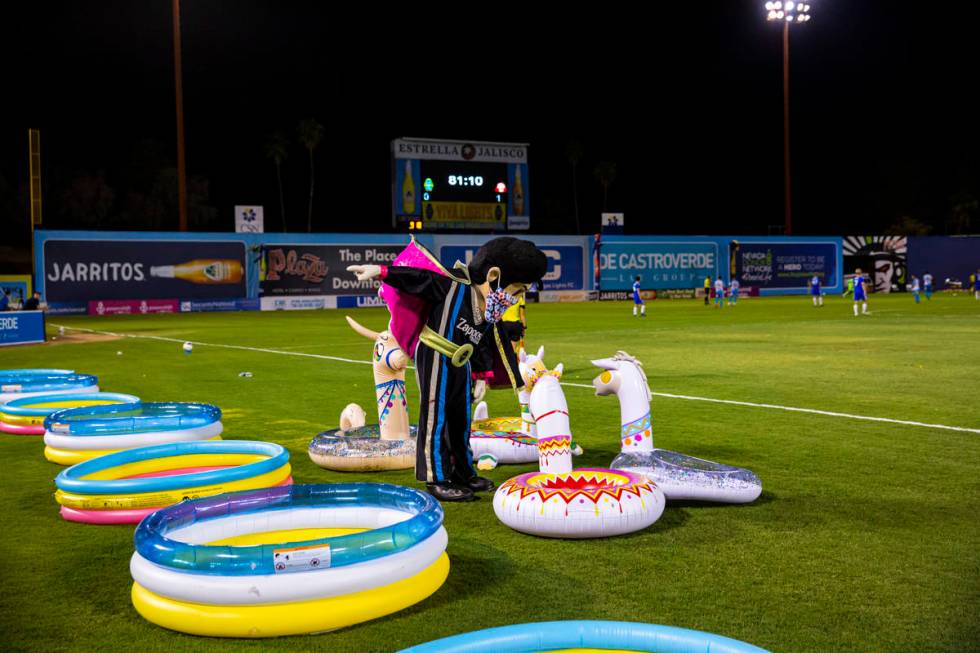Las Vegas Lights FC mascot Cash interacts with blowup llamas during the second half of a USL so ...