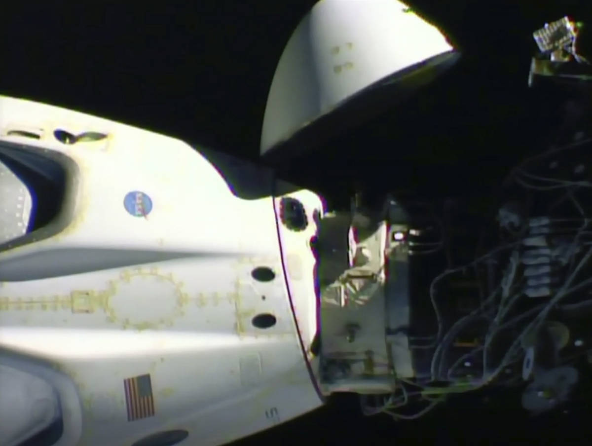 This image from video made available by NASA shows the SpaceX Crew Dragon capsule, left, before ...