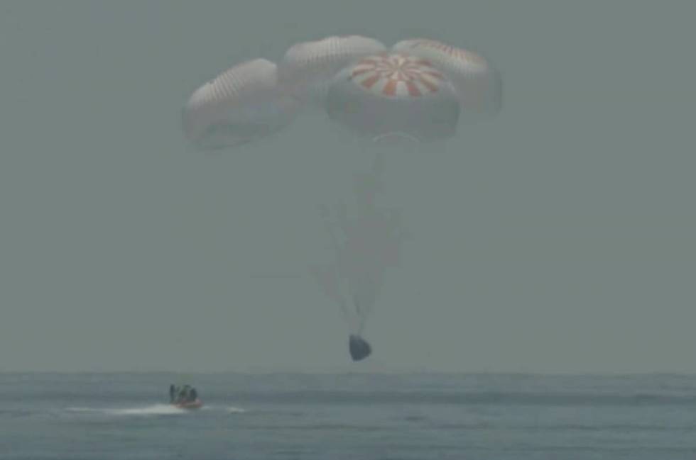 In this frame grab from NASA TV, the SpaceX capsule splashes down Sunday, Aug. 2, 2020 in the G ...