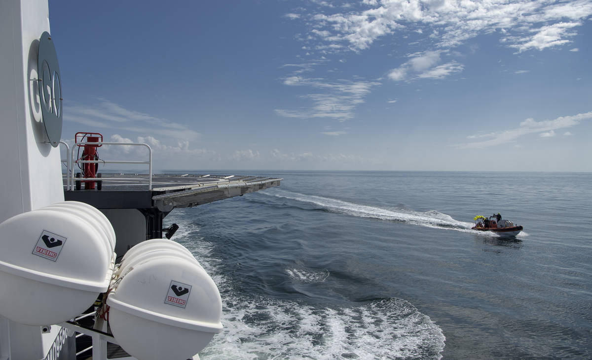SpaceX support teams are deployed on fast boats from the SpaceX GO Navigator recovery ship ahea ...