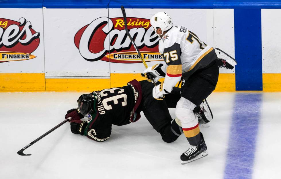 Arizona Coyotes' Alex Goligoski (33) is checked by Vegas Golden Knights' Ryan Reaves (75) durin ...