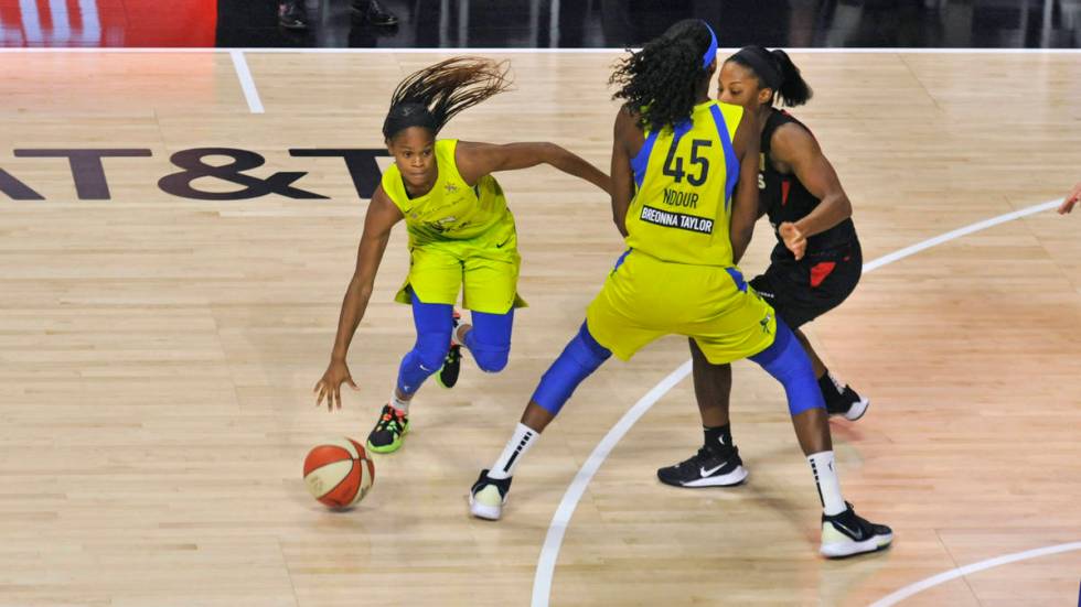 Dallas Wings' Astou Ndour (45) sets a pick on Las Vegas Aces' Lindsay Allen, right, for teammat ...