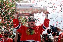 Chicago Blackhawks right wing Patrick Kane (88) holds up the Stanley Cup Trophy during a rally ...