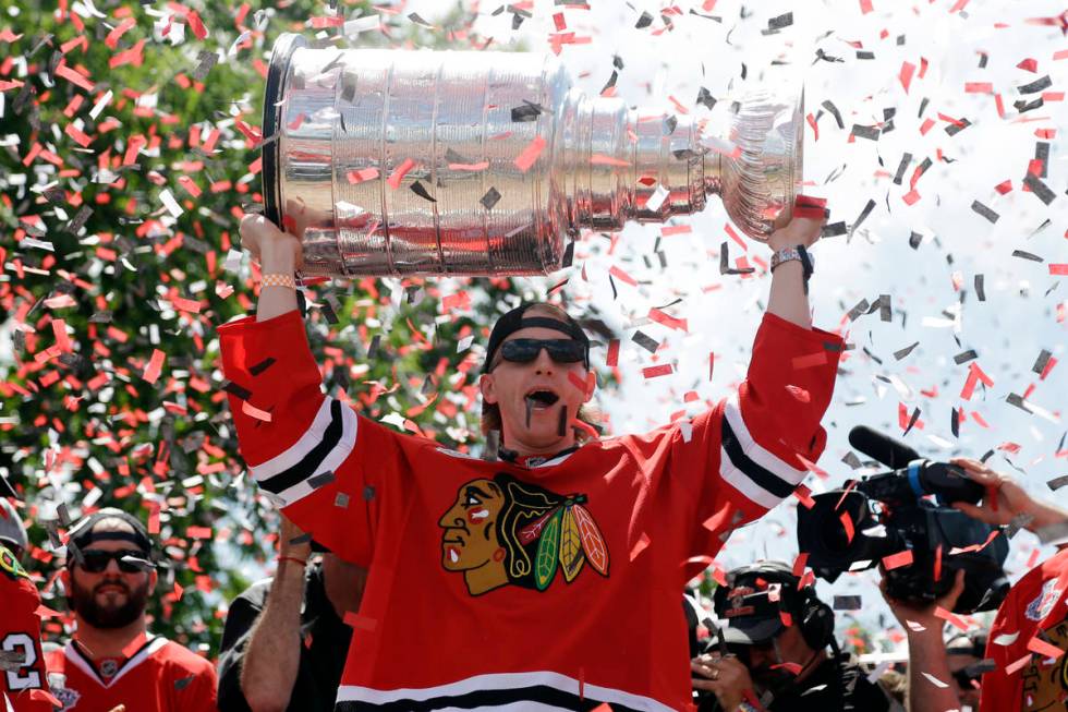 Chicago Blackhawks right wing Patrick Kane (88) holds up the Stanley Cup Trophy during a rally ...