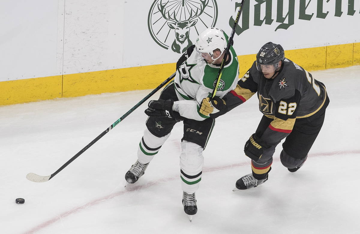 Dallas Stars' Radek Faksa (12) and Vegas Golden Knights' Nick Holden (22) battle for the puck d ...