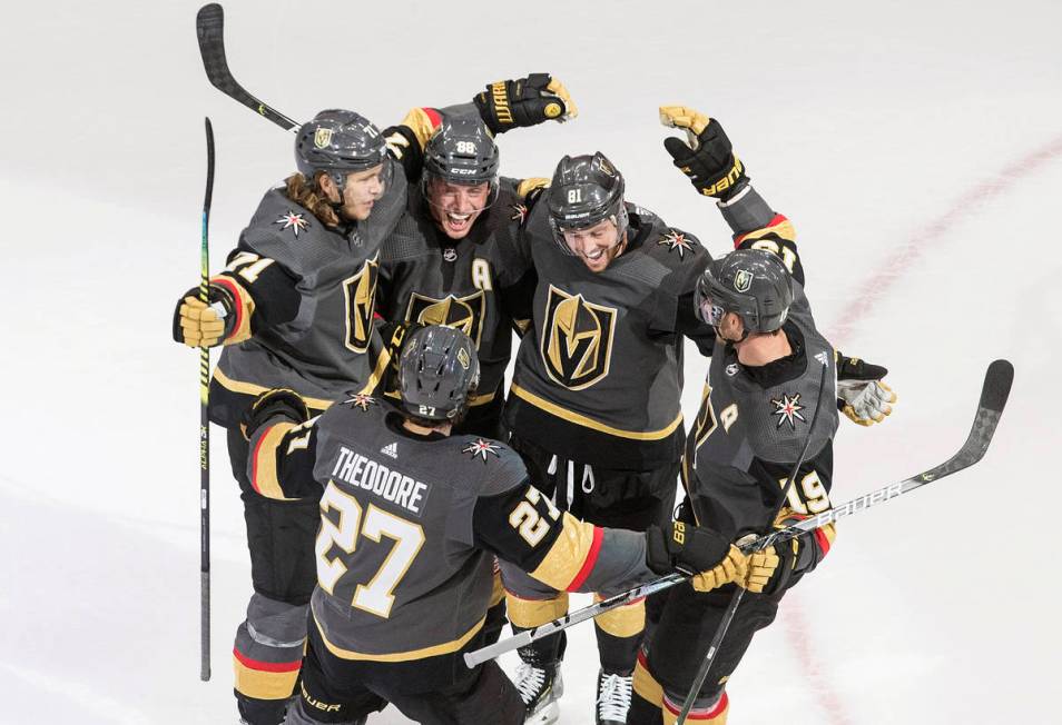 Vegas Golden Knights celebrate a goal during the third period of an NHL hockey playoff game aga ...