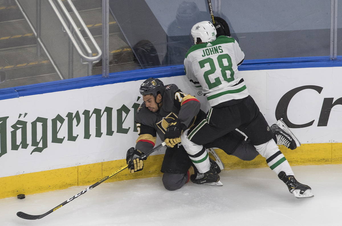 Dallas Stars' Stephen Johns (28) checks Vegas Golden Knights' Ryan Reaves (75) during the third ...