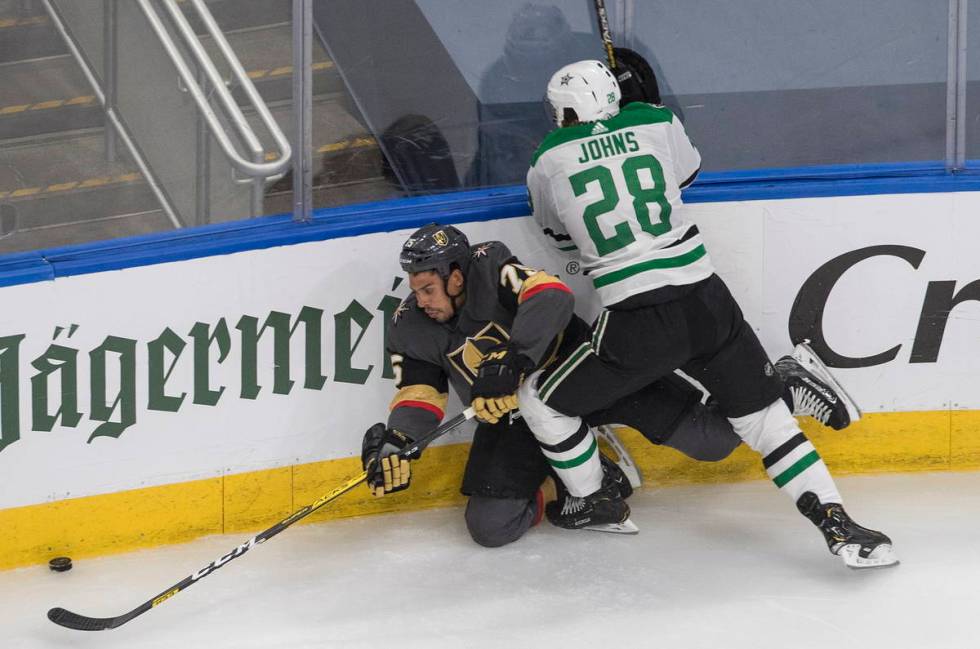 Dallas Stars' Stephen Johns (28) checks Vegas Golden Knights' Ryan Reaves (75) during the third ...