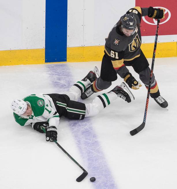 Dallas Stars' Mattias Janmark (13) is tripped up by Vegas Golden Knights' Mark Stone (61) durin ...