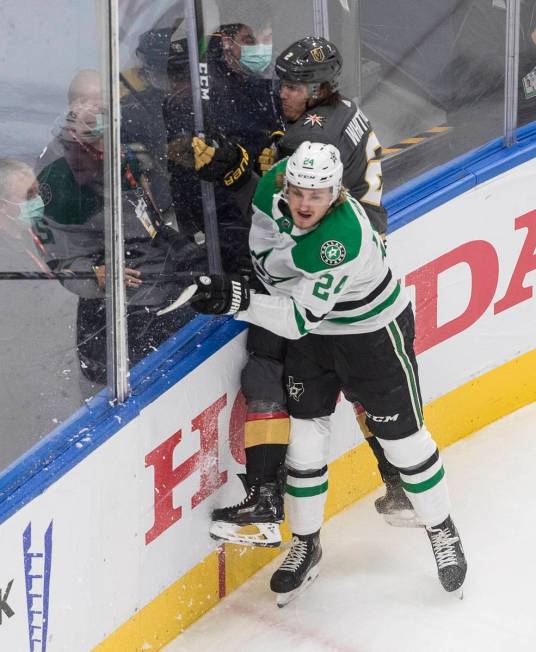 Dallas Stars' Roope Hintz (24) checks Vegas Golden Knights' Zach Whitecloud (2) during the firs ...