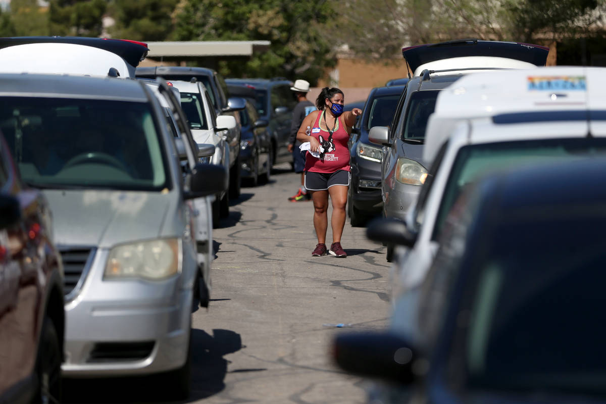 Cars line up during the C-U-R-E Drive Through Resource Fair at Mater Academy in east Las Vegas, ...