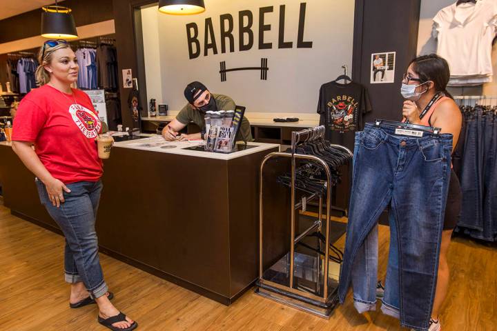 Floor lead Jessica Rimando, right and salesman Tommy Ruiz chat with customer Amanda Crouch at B ...