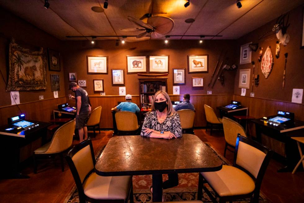 Donna Rocker, owner of Black Mountain Grill, poses by a gaming lounge area at the restaurant an ...