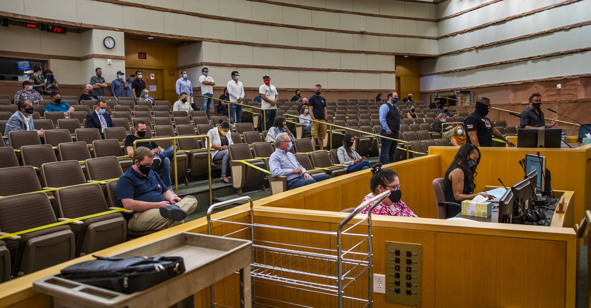 Participants line up to speak during the public commentary time about capping of fees charged b ...