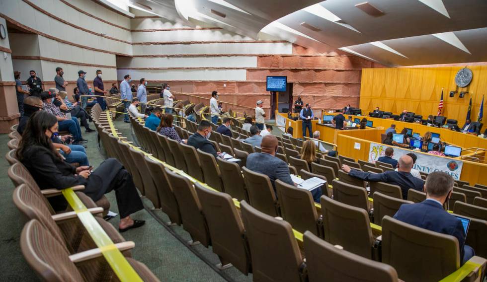 Participants line up to speak during the public commentary time about capping of fees charged b ...