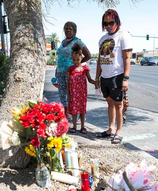 Ana Hardware, left, Tiffany Joseph and her daughter Jordan, 6, visit a makeshift roadside memor ...