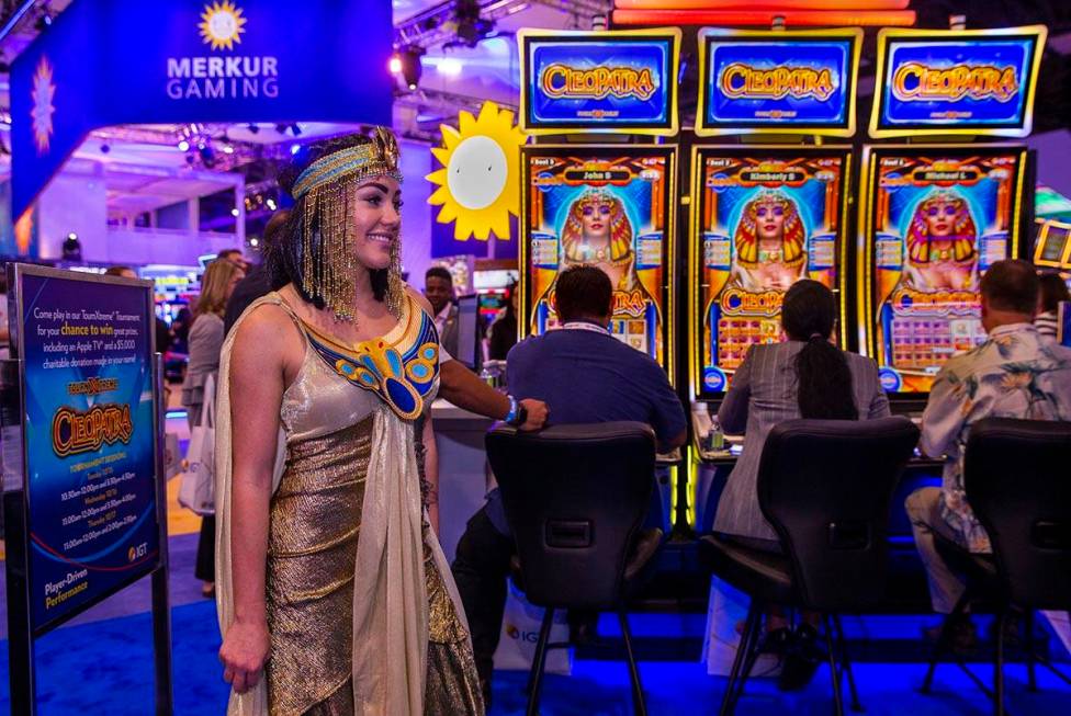 Cleopatra is on hand as attendees play games on display in the IGT exhibition space during the ...