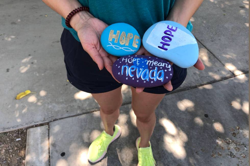 Angela Edgeworth holds rocks in Lorenzi Park in Las Vegas,Tuesday, Aug. 4, 2020. Edgeworth sist ...