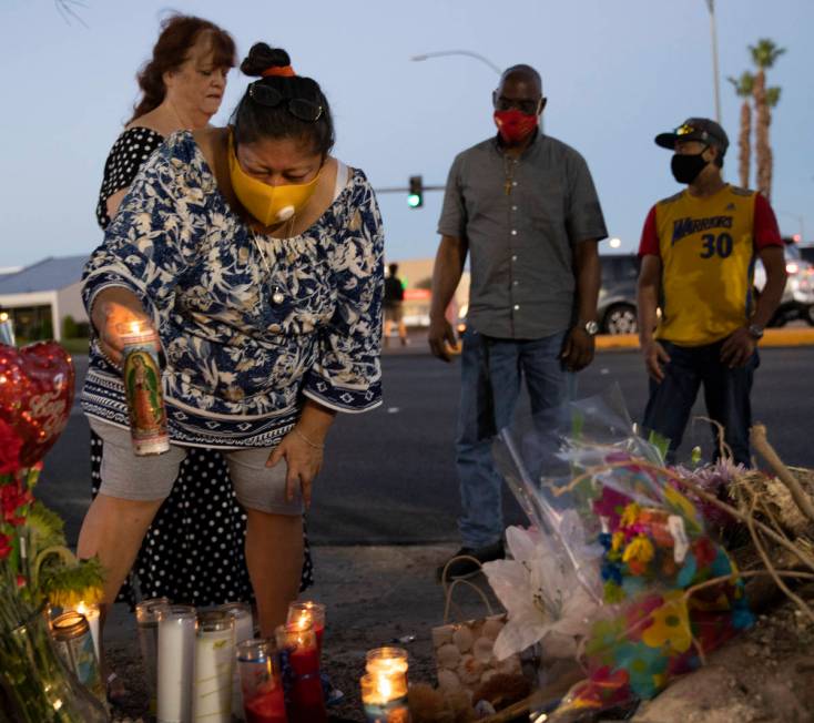 Minerva Rodriguez, left, places a candle with a group of others during a vigil for Nelly Amaya- ...