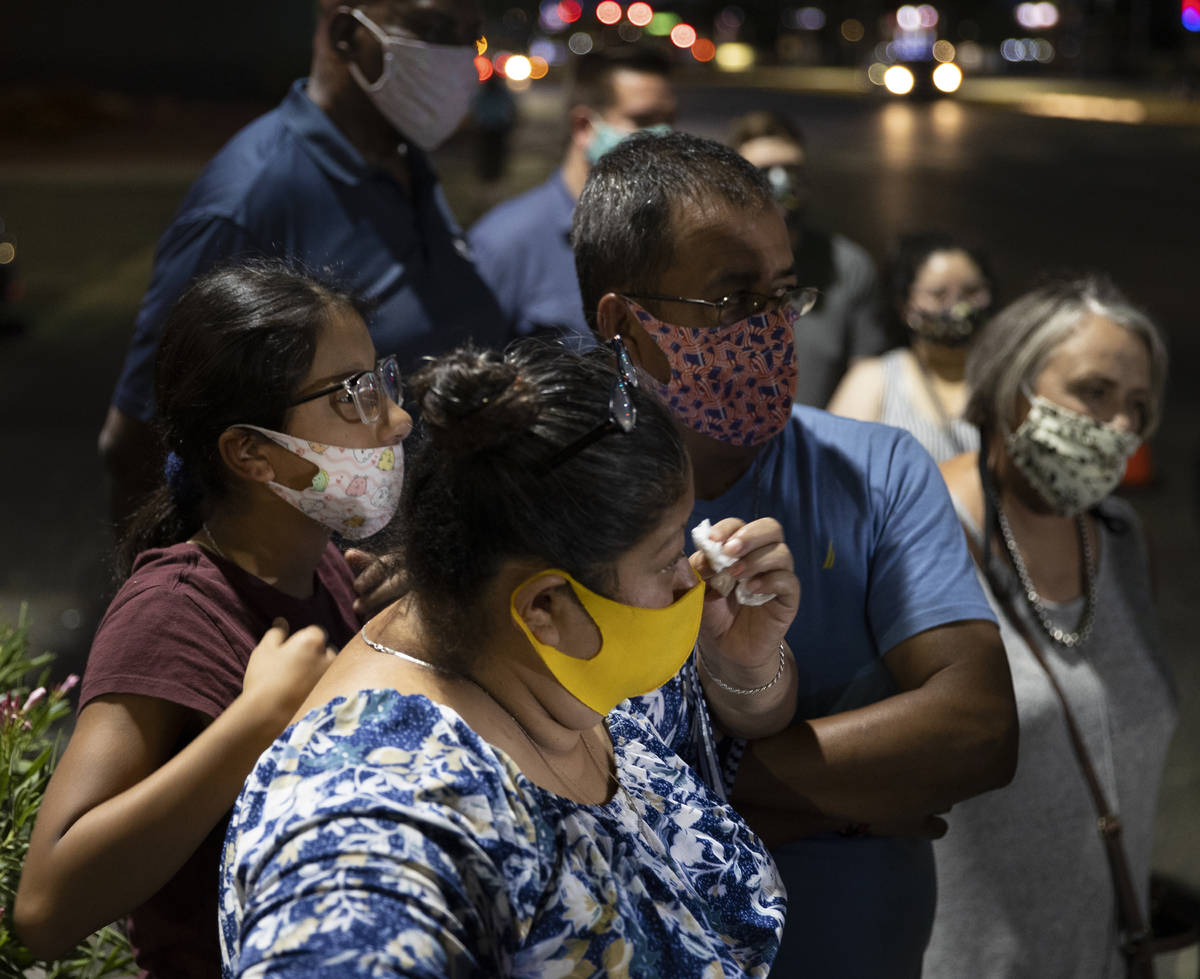 Minerva Rodriguez, middle, is comforted by friends and family during a vigil for Nelly Amaya-Ra ...