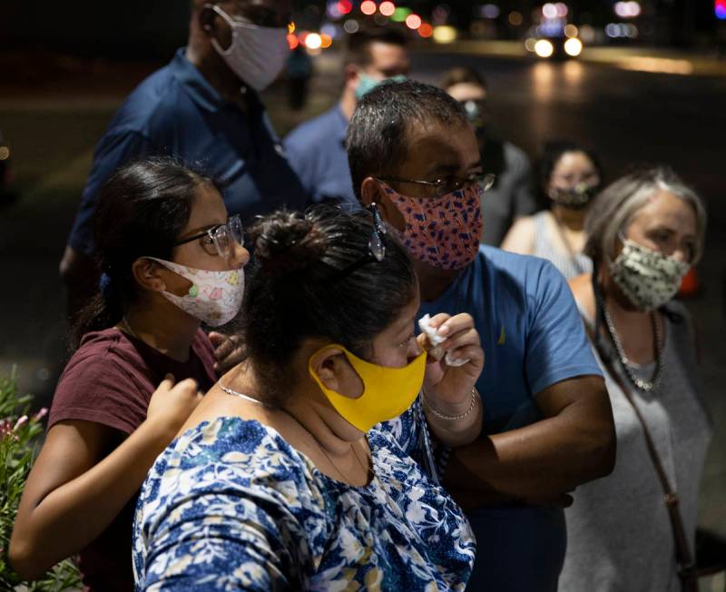 Minerva Rodriguez, middle, is comforted by friends and family during a vigil for Nelly Amaya-Ra ...