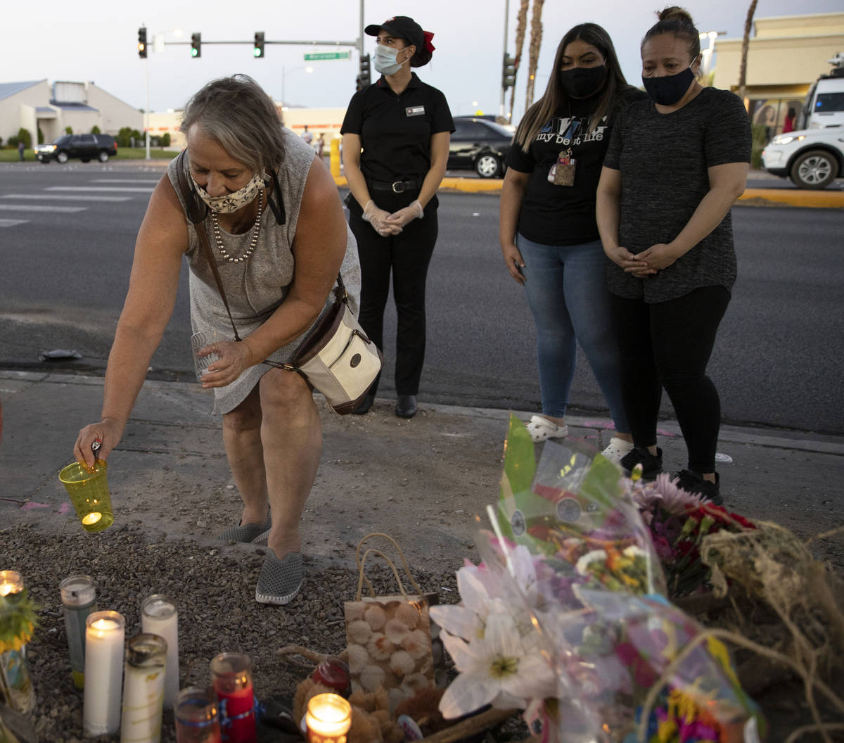 Suzan Woodbeck, left, places a candle with a group of others during a vigil for Nelly Amaya-Ram ...