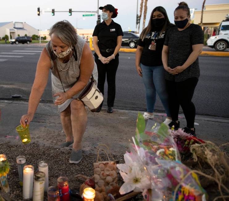 Suzan Woodbeck, left, places a candle with a group of others during a vigil for Nelly Amaya-Ram ...