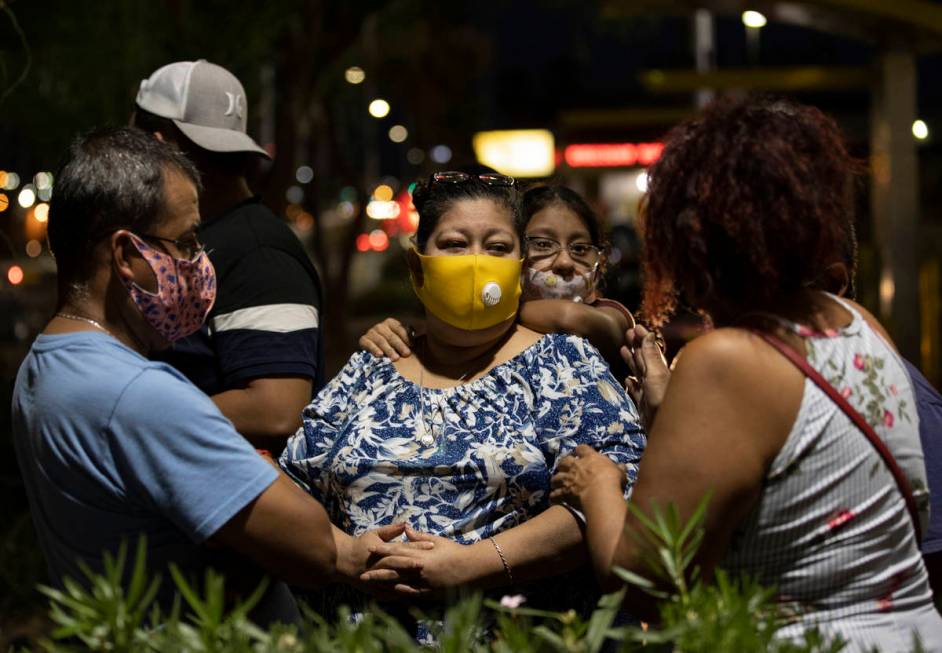 Minerva Rodriguez, middle, is comforted by friends and family during a vigil for Nelly Amaya-Ra ...