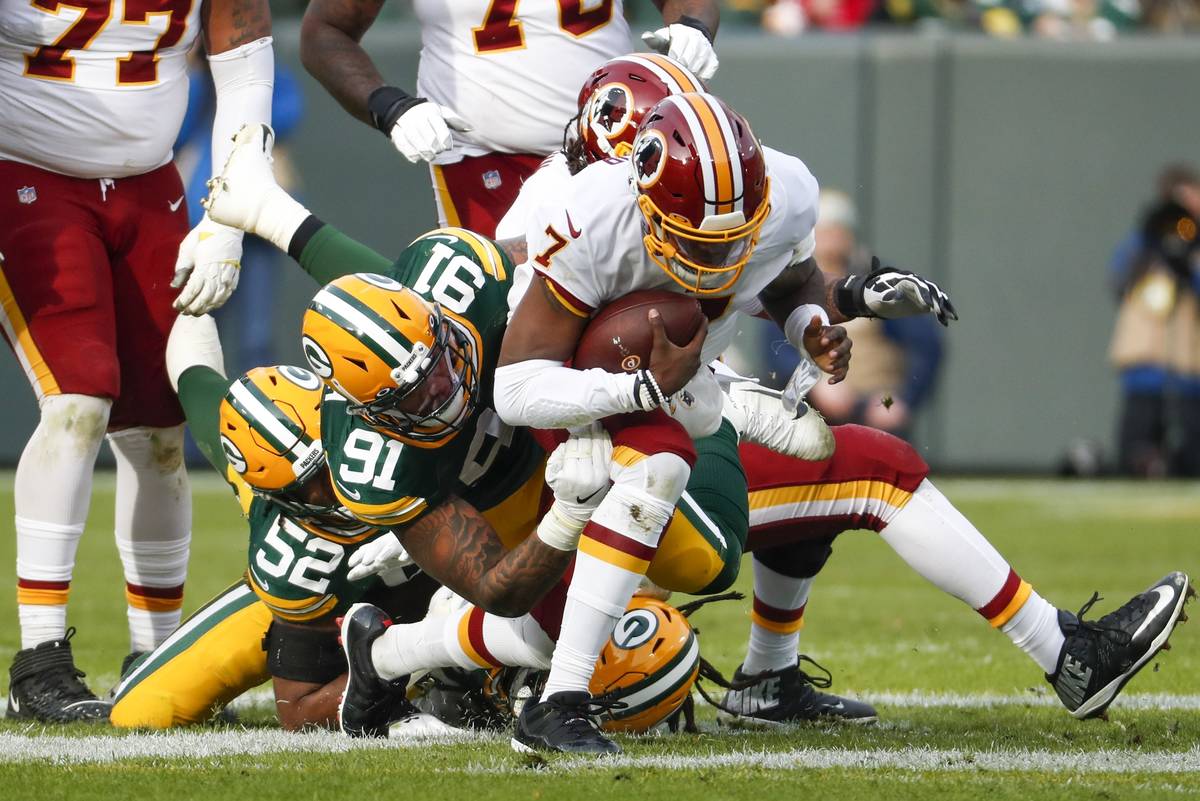 Green Bay Packers' Preston Smith sacks Washington Redskins quarterback Dwayne Haskins during th ...