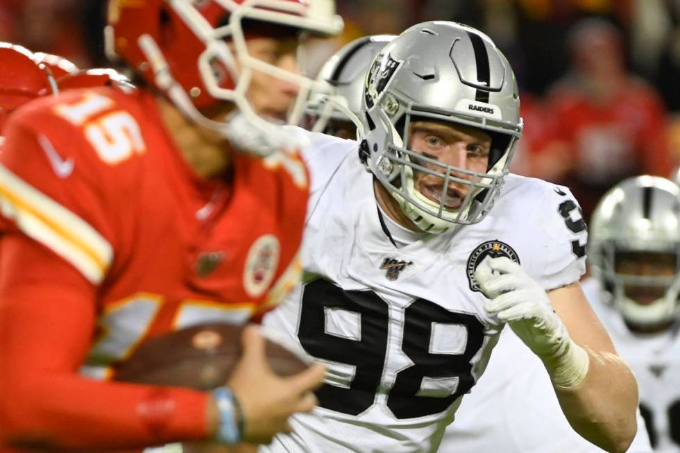 Oakland Raiders defensive end Maxx Crosby (98) chases Kansas City Chiefs quarterback Patrick Ma ...