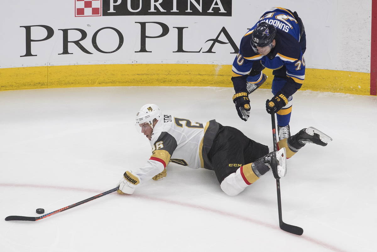 St. Louis Blues' Oskar Sundqvist (70) checks Vegas Golden Knights Paul Stastny (26) during the ...