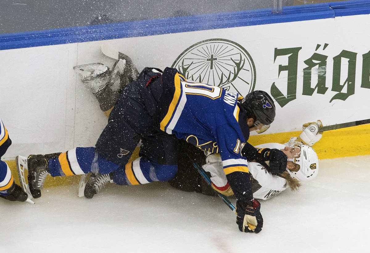 St. Louis Blues' Brayden Schenn (10) checks Vegas Golden Knights' William Karlsson (71) during ...