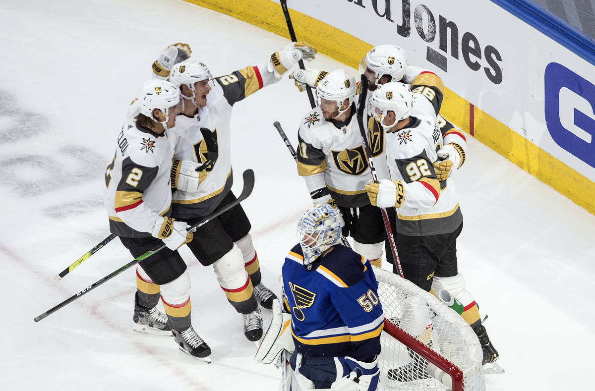 St. Louis Blues goalie Jordan Binnington (50) looks on as the Vegas Golden Knights celebrate a ...