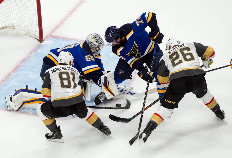 St. Louis Blues goalie Jordan Binnington (50) makes a save as teammate Justin Faulk (72), Vegas ...