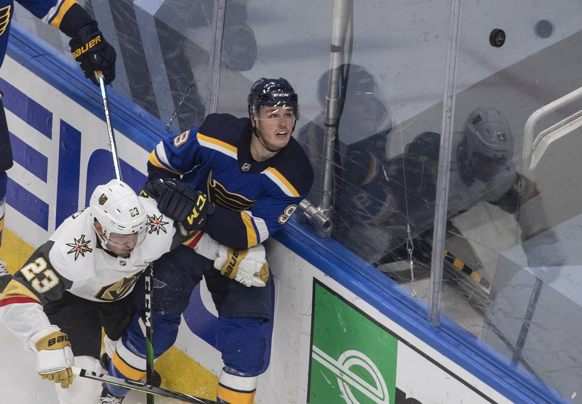 St. Louis Blues' Sammy Blais (9) and Vegas Golden Knights' Alec Martinez (23) battle for the pu ...