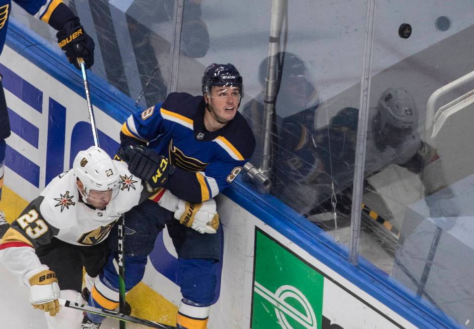 St. Louis Blues' Sammy Blais (9) and Vegas Golden Knights' Alec Martinez (23) battle for the pu ...