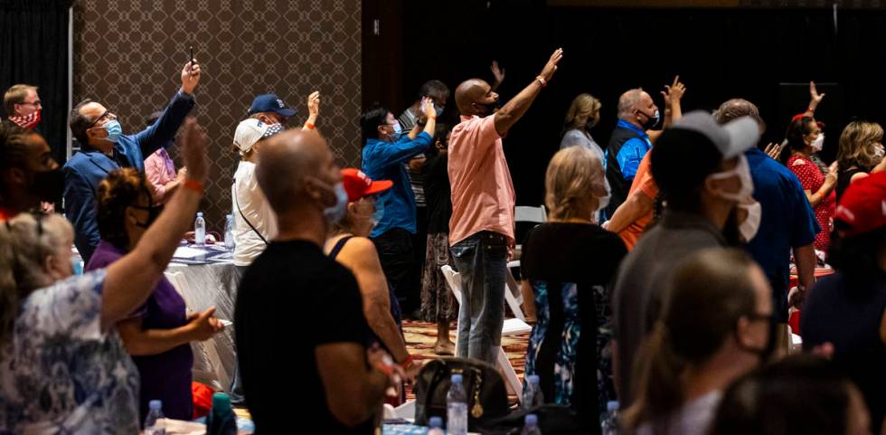 People react as a song is performed during an "Evangelicals for Trump" campaign event ...