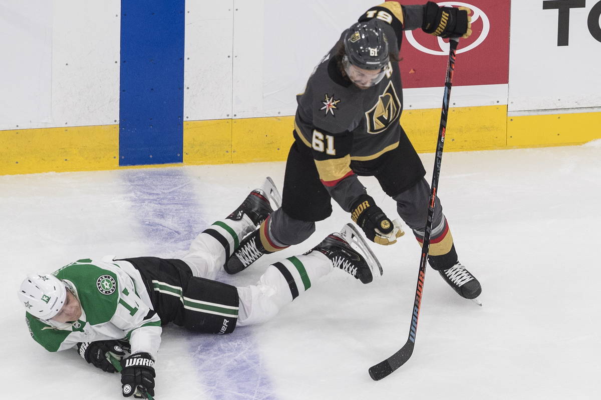 Dallas Stars' Mattias Janmark (13) is tripped up by Vegas Golden Knights' Mark Stone (61) durin ...